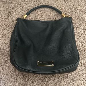 Lightly used black Marc Jacobs Purse with gold accents, comes with a long strap